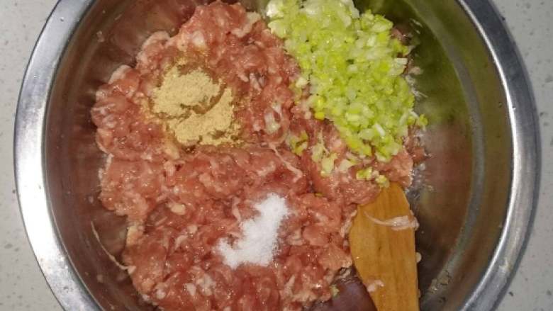 萝卜汆丸子,加葱沫、姜沫(姜粉)和少许盐,使肉馅入味,继续顺一个方向搅拌。