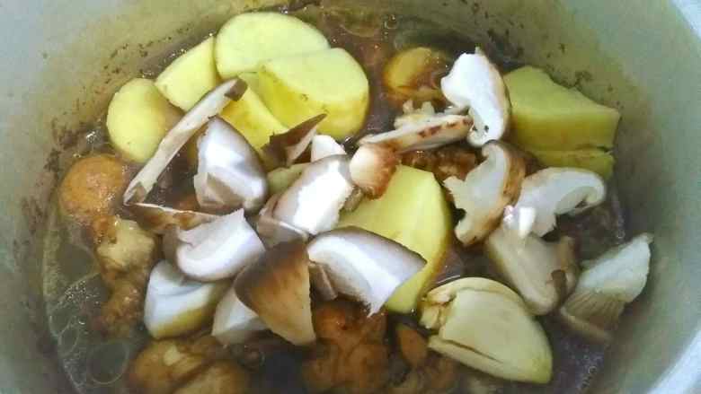 电饭煲焖鸡腿,待水再次烧开后5分钟左右加入土豆,香菇,蒜头