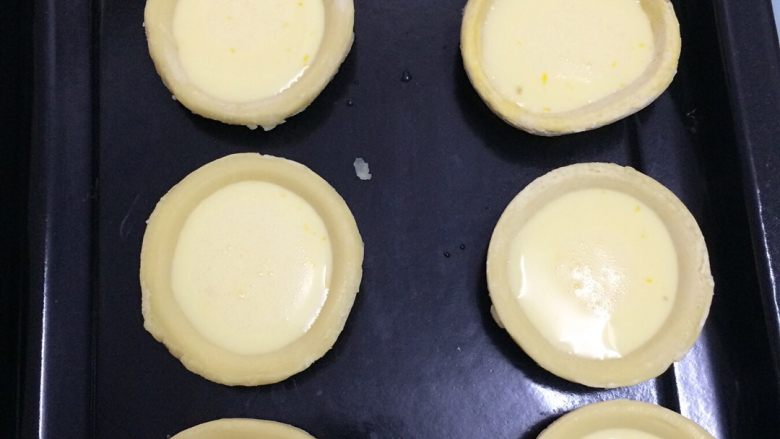 蛋挞,蛋挞皮提前十分钟从冰箱拿出来，一个一个排好在烤盘上，倒入蛋液，倒八成，如果倒太满，在烤的过程中会膨胀起来，如果喜欢吃有水果的口味，可加入芒果、蓝苺……果粒