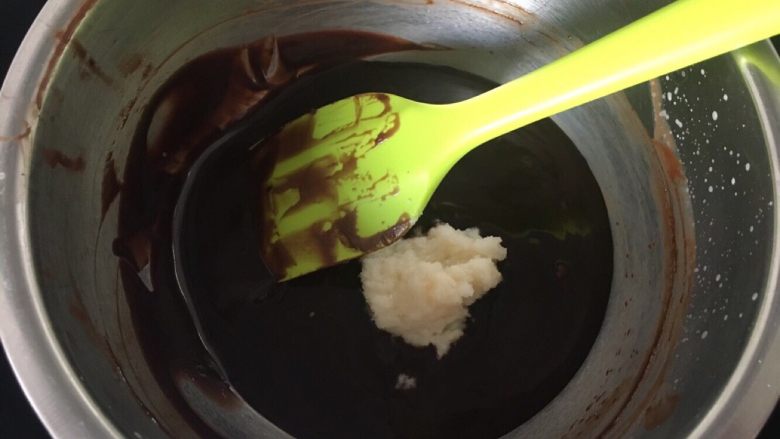 豌豆黄夹心巧克力慕斯,搅拌均匀后把用牛奶泡好的吉利丁倒入黑巧克力糊,搅拌融化
