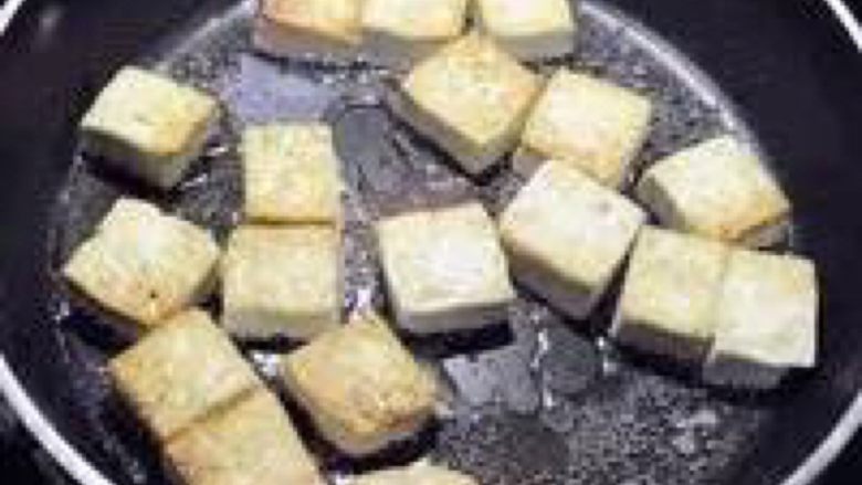 香煎嫩豆腐,翻面的时候一定要注意!把火调成小火,以防你翻慢了豆腐焦掉…还有,不要用筷用力夹豆腐,会碎的好吗!!!用锅铲和筷子一起配合
全部翻过来后,再把火调成中火煎至另一面金黄