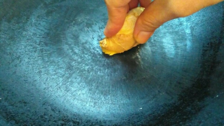 花鲳豆腐汤,开火,锅烧热,用姜擦拭,