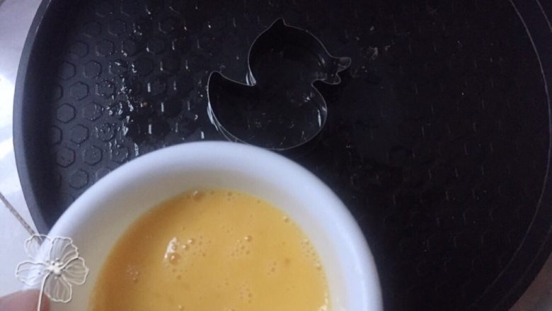 宝宝创意餐--卡通肉酱意面,热锅刷油,摆好模具将调好的蛋液倒入。