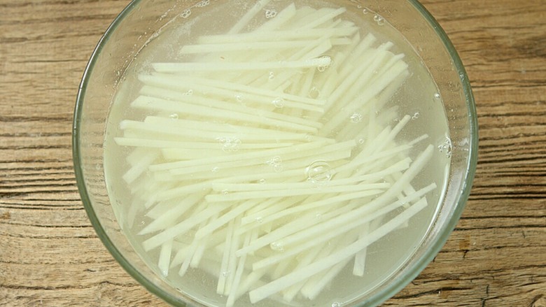 夏日小菜凉拌土豆丝,切好的土豆丝用清水浸泡,再重复浸泡清洗几次,主要是为了浸泡出土豆的淀粉,这样口感才更爽脆。