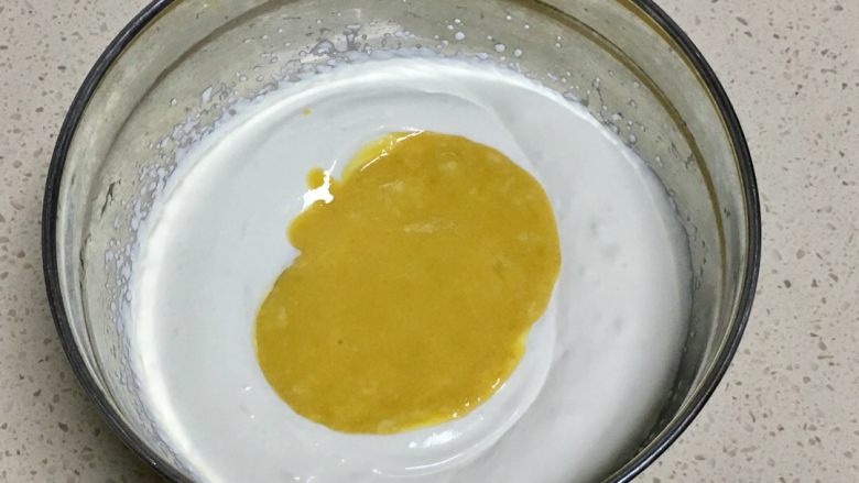 三色慕斯水果杯,把芒果糊放入打发好的淡奶油里,搅拌均匀,芒果慕斯糊做好了