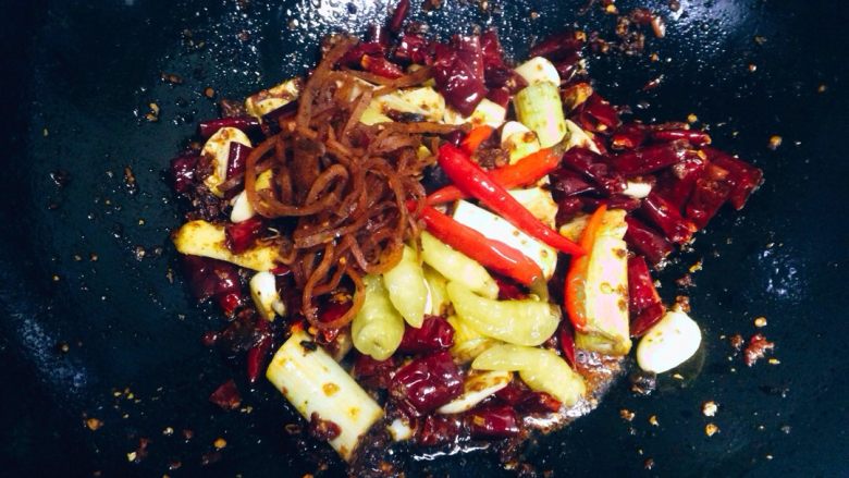 香辣烤鱼,下入泡小米椒,萝卜干炒出香味。