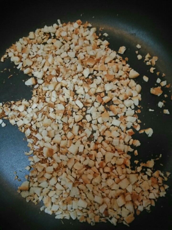 土司面包卷,把吐司边切成碎末状,用不粘锅烘干