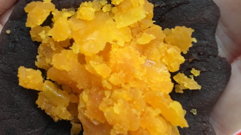 红豆蛋黄陷月饼,把豆沙团子压扁中间加入5~7g蛋黄,揉成团待用