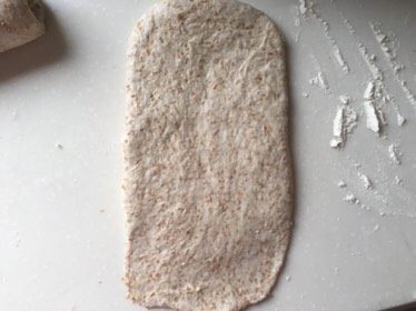 超柔软全麦吐司,取一个面团擀开,擀薄底边,自上而下卷起