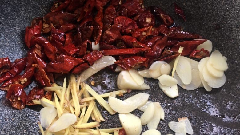 腊味春笋,将蒜瓣，姜丝，干辣椒中火煸炒出香，辣椒要炒脆。