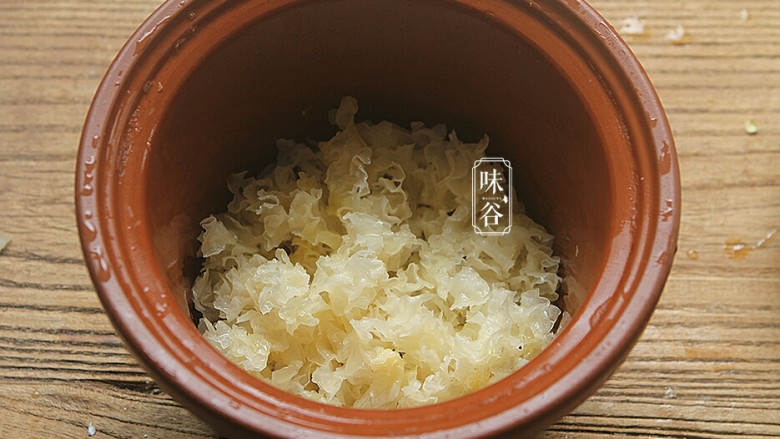 莲子百合薏米银耳羹,将银耳碎放进炖煲里;