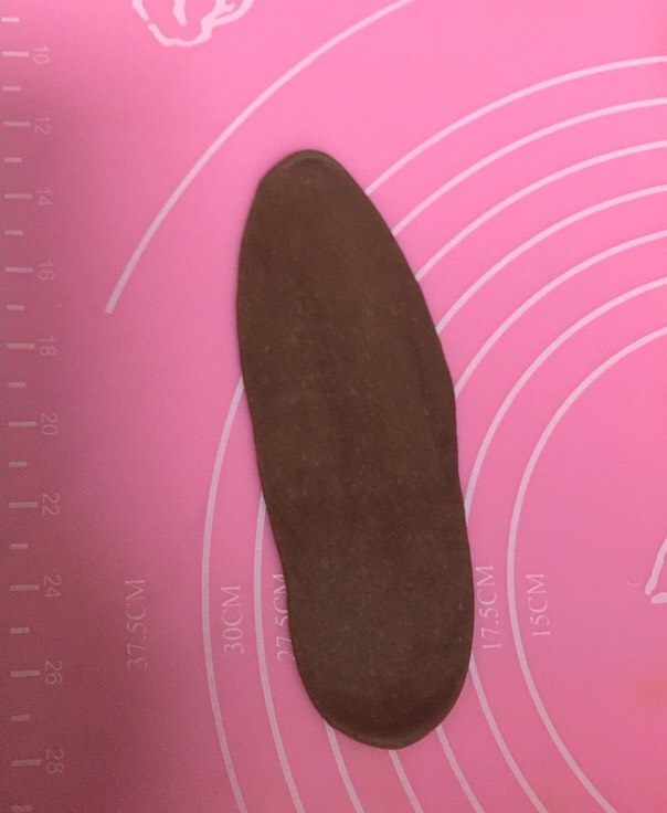 性感的豹纹控吐司面包,取一个深棕色的面团,用擀面杖擀成长舌状,如图。