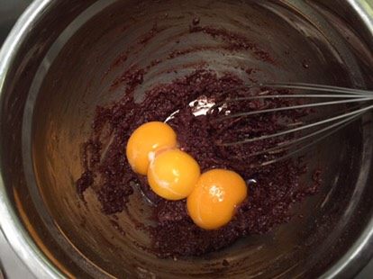 巧克力杯子蛋糕,加入牛奶油混合物,拌至无干粉后磕入蛋黄