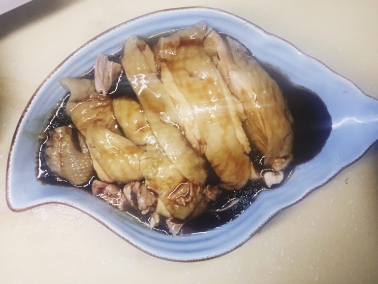 口水鸡,把大鸡腿,背面划几刀去掉两节腿骨,再切成块,整齐的码到盘子中,先倒入调好的调料。