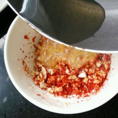 蒜泥白肉,油热了,倒入辣椒面。此时很烫,小心!
