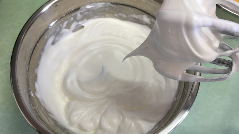 水果盒子蛋糕,将蛋白分三次加入细砂糖,用电动打蛋器进行打发,打到蛋白提起有大弯勾。
