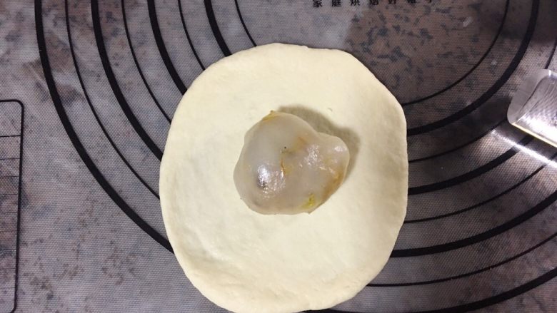 咸蛋黄肉松麻薯面包,将松弛好的小面团擀圆,包入馅料,收口捏紧朝下,依次做好全部。