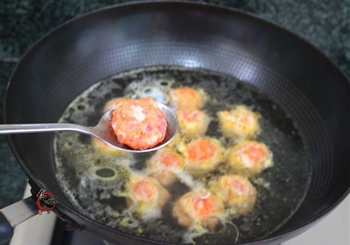 咖喱猪肉胡萝卜丸子,烧开适量水,水中调入食用油,将肉沫搓成丸子,放入锅中,煮至熟透