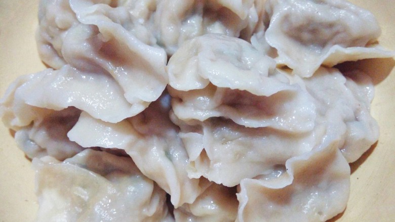 大肉土豆饺子,烧水沸腾下饺子,片刻煮熟捞出盛盘。