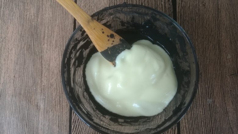拉花斑马心戚风,从其中一份蛋糊内取一小勺加入竹炭粉糊内,翻拌均匀。