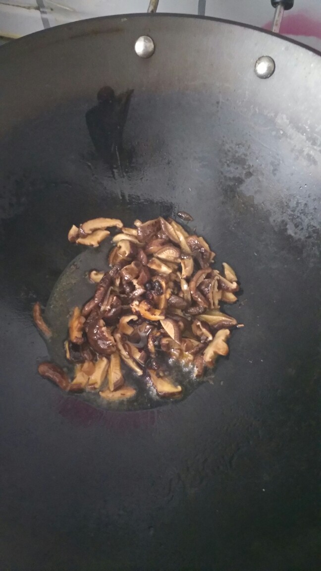 青椒肉丝夹馍,锅里放油,放入香菇翻炒