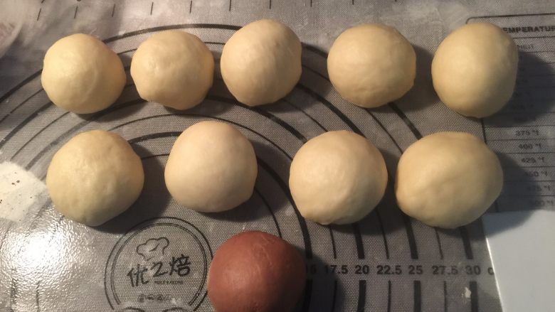 南瓜形豆沙包,取出排气,分成10份,每份42g左右,滚圆醒发15分钟,其中1份加点可可粉(其实这个可可粉团可以留少点,20克就够了)