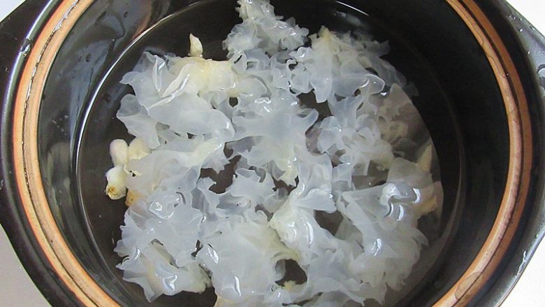 枇杷百合银耳羹,锅煲中加入适量水,放入泡好的银耳,开小火慢煮