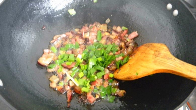 腊肉糯米卷,炒勺放一勺油,不要多,一汤勺足够,放入葱白部分炒香,在放入腊肉肉丁翻炒,炒到腊肉肥肉部分微微透明,放入葱叶