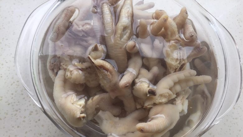 香醋凤爪,煮好的鸡爪在冷水中洗净油末后,再放入冷开水中再过一下水