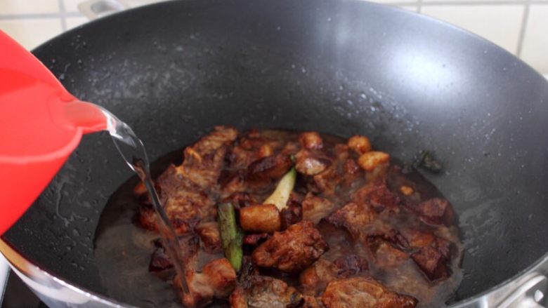 干豆角烧肉,10.炒上色,一次加入足量的水,即水略漫过肉。