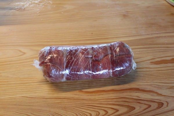 惠灵顿牛肉,将牛肉用生火腿包住,保鲜膜紧紧包好,放冰箱冷藏定型。