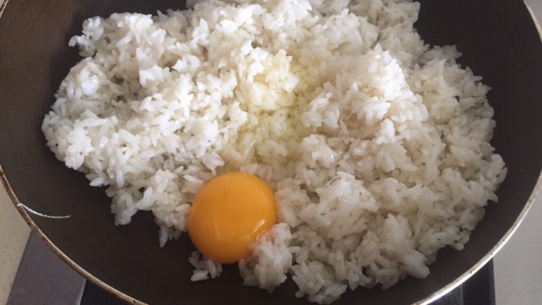 炒饭,炒到米饭沾满油后,直接磕入鸡蛋