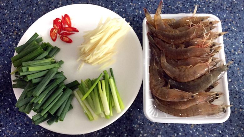 姜葱爆虾,食材处理:
1)虾的处理有点麻烦,剪须、剪头上的刺,挤掉头上的脏东西,挑去背上的虾线。
2)姜洗干净去皮切丝。
3)葱洗干净去头,切小段,葱白和葱叶分开。
4)辣椒洗干净切小片