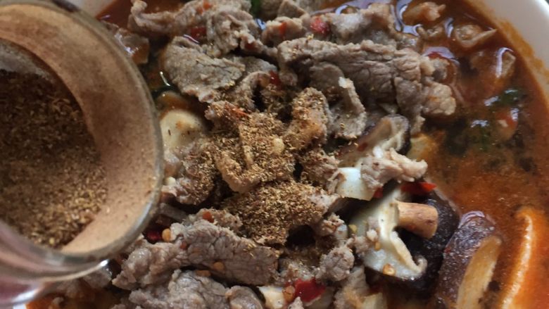 水煮牛肉,汤和肉一起倒进焯好菜的大碗里,加花椒粉