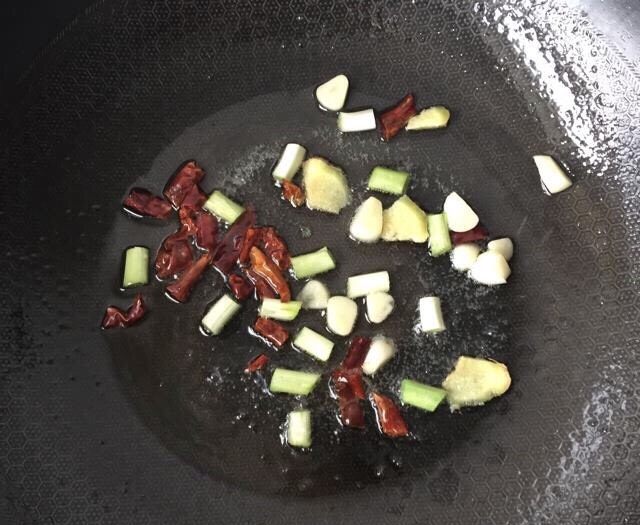 香辣啤酒鸭,锅烧热放适量食用油,葱姜蒜、干辣椒下锅爆香炒出辣味