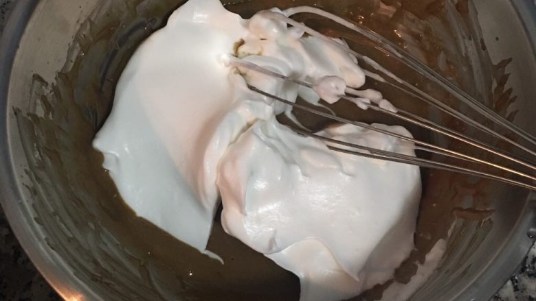 摩卡咖啡戚风蛋糕卷,接着取2瓢蛋白霜混入咖啡蛋黄液中轻拌混匀,