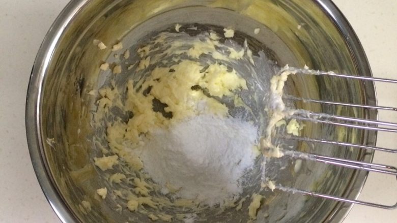 蔓越莓玛格丽特,然后加入糖粉,先用电动打蛋器低速打至混合。