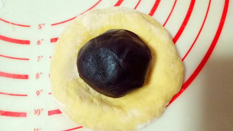 南瓜豆沙包,取一小块面团,用手掌心按压成饼,(用擀面杖也可以哦) 放上豆沙馅,虎口手法包起来。