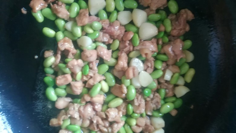 辣椒青豆炒鸡丁,下已经煮过的豆子继续炒两三分钟,炒至豆子表皮有点微微皱起会比较香。
