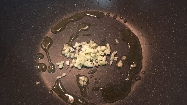 小茴香战斧猪排佐栉瓜丝,炒锅内下橄榄油,炒香蒜头。