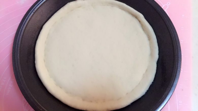 火腿披萨,首先用手在面饼边缘处按瘪成图片状态