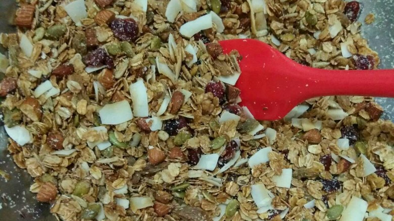 Granola格拉诺拉麦片,见麦片烤制到金黄色即可取出,迅速的倒入大碗和果干混合,趁热搅拌均匀。
如果你也是不锈钢的大腕,这个时候会很热,小心不要被烫到。