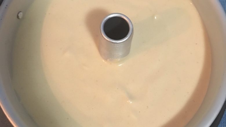 紅玉奶茶戚風蛋糕,装入模具中,要提起模具轻敲桌面,让底下的空气跑出来。