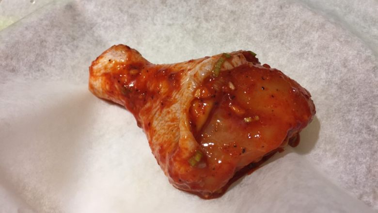 韩式香蒜辣烤鸡,腌好的鸡肉,用油纸或者锡箔纸包裹,放在烤盘里。