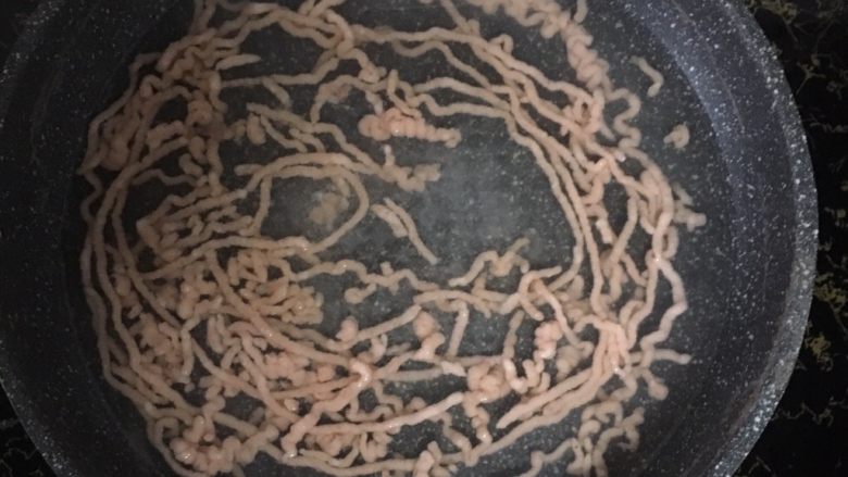 宝宝辅食之黄瓜胡萝卜虾条,起锅烧水,水开后转中小火,挤入虾滑条,煮至虾滑条浮起。