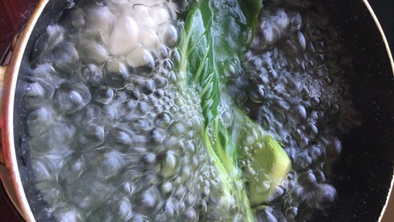 油菜鳕鱼蛋黄粥,为了节省时间,煮鸡蛋的锅里水烧开后将油菜洗净,下水焯几秒钟捞出~不嫌麻烦的也可以分开煮哈~