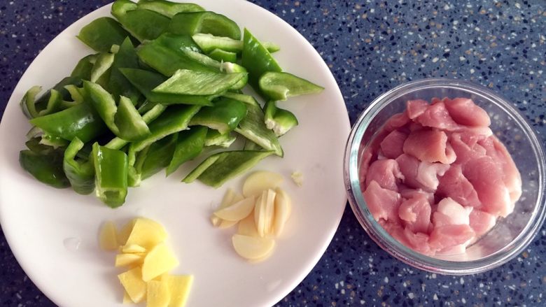 青椒肉片,食材处理:
1)瘦肉洗干净切片。
2)青椒洗干净切小块。
3)姜洗干净去皮切片。
4)蒜剥皮洗干净切片。
