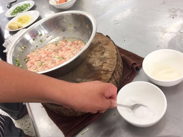 正宗的扬州特色菜-红烧狮子头,放一点糖和一点盐,糖是提鲜的。盐是整个调味的关键,分多次少量放盐,然后用力的搅拌。
