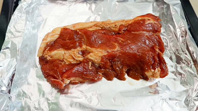只吃一碗饭之黯然销魂饭,烤盘上垫锡纸,把肉放上去,进烤箱烤15分钟。
