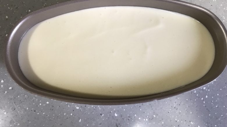 轻乳酪蛋糕,蛋糕糊倒入模具78分满。轻轻晃动模具,使蛋糕糊表面均匀。